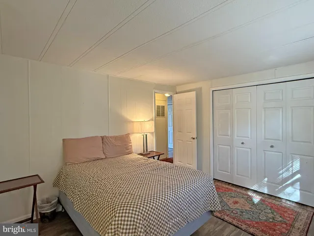 a bedroom with a bed and a night stand