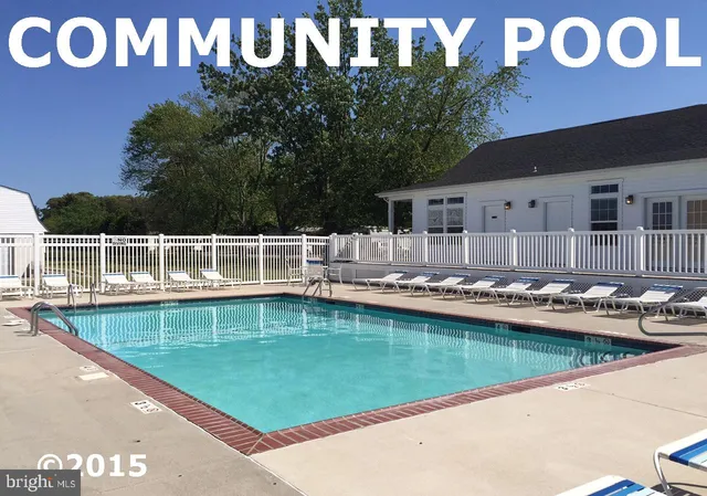 a view of a swimming pool with a lawn chairs