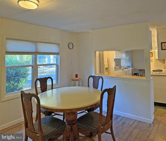 a view of a dining room with furniture and window