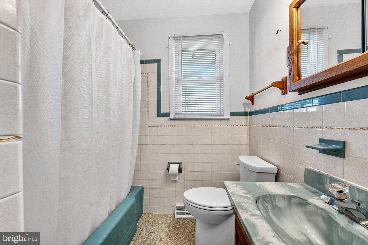 3 Delotto Drive Hamilton, NJ 08619 - Photo 12 of 18 a bathroom with a sink a toilet and a mirror