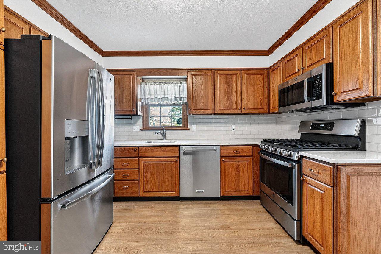 3 Delotto Drive Hamilton, NJ 08619 - Photo 6 of 18 a kitchen with stainless steel appliances granite countertop a refrigerator stove and sink