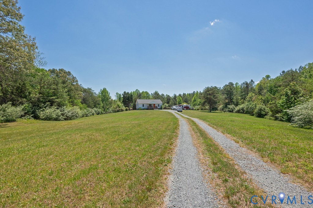4336 Hells Bend Road Palmyra, VA 22963 - Photo 28 of 35 Gravel driveway leading to a white residence with