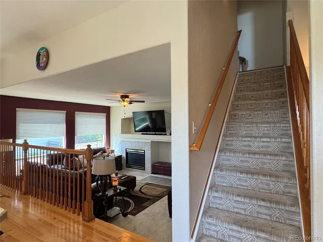 a view of a livingroom with furniture and staircase