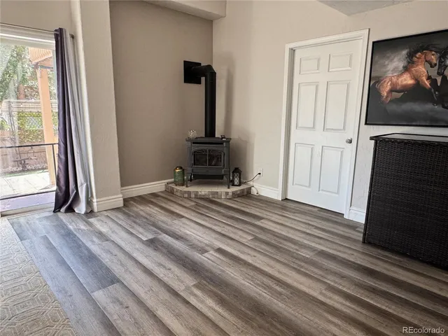 a view of a room with wooden floor and a flat screen tv