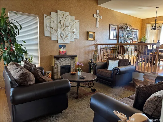 a living room with furniture fireplace and a potted plant
