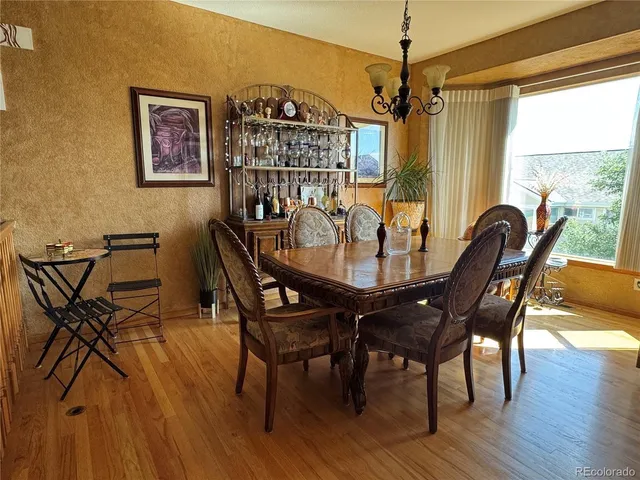a dining room with furniture window and wooden floor