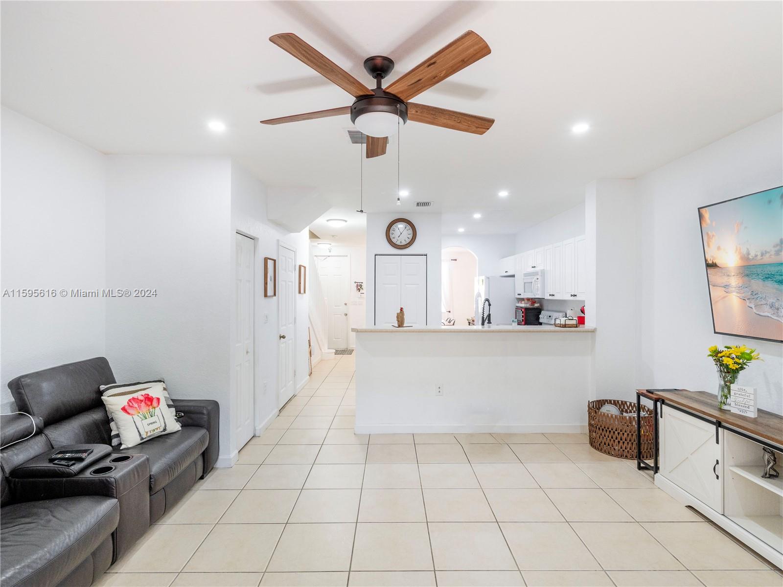 9237 Southwest 227th Street, Unit 6 Cutler Bay, FL 33190 - Photo 12 of 41 a living room with furniture and a chandelier