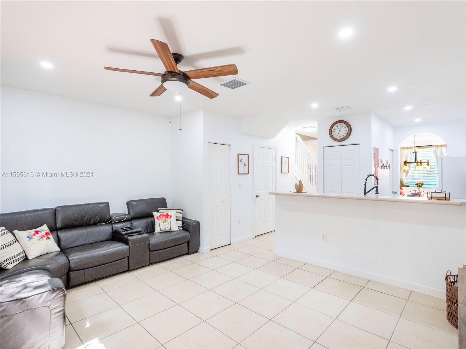 9237 Southwest 227th Street, Unit 6 Cutler Bay, FL 33190 - Photo 13 of 41 a living room with furniture and a clock