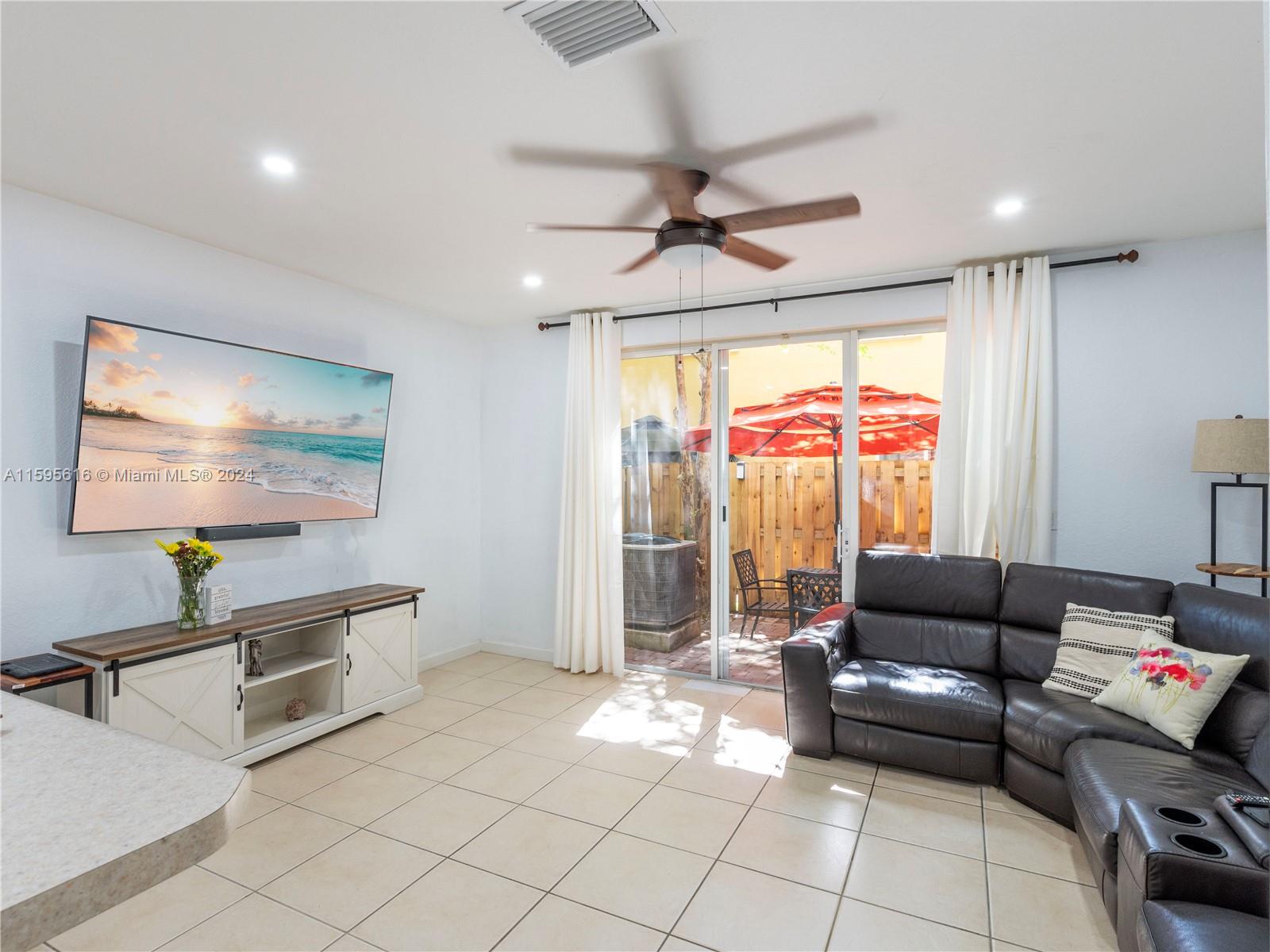 9237 Southwest 227th Street, Unit 6 Cutler Bay, FL 33190 - Photo 14 of 41 a living room with furniture and a flat screen tv