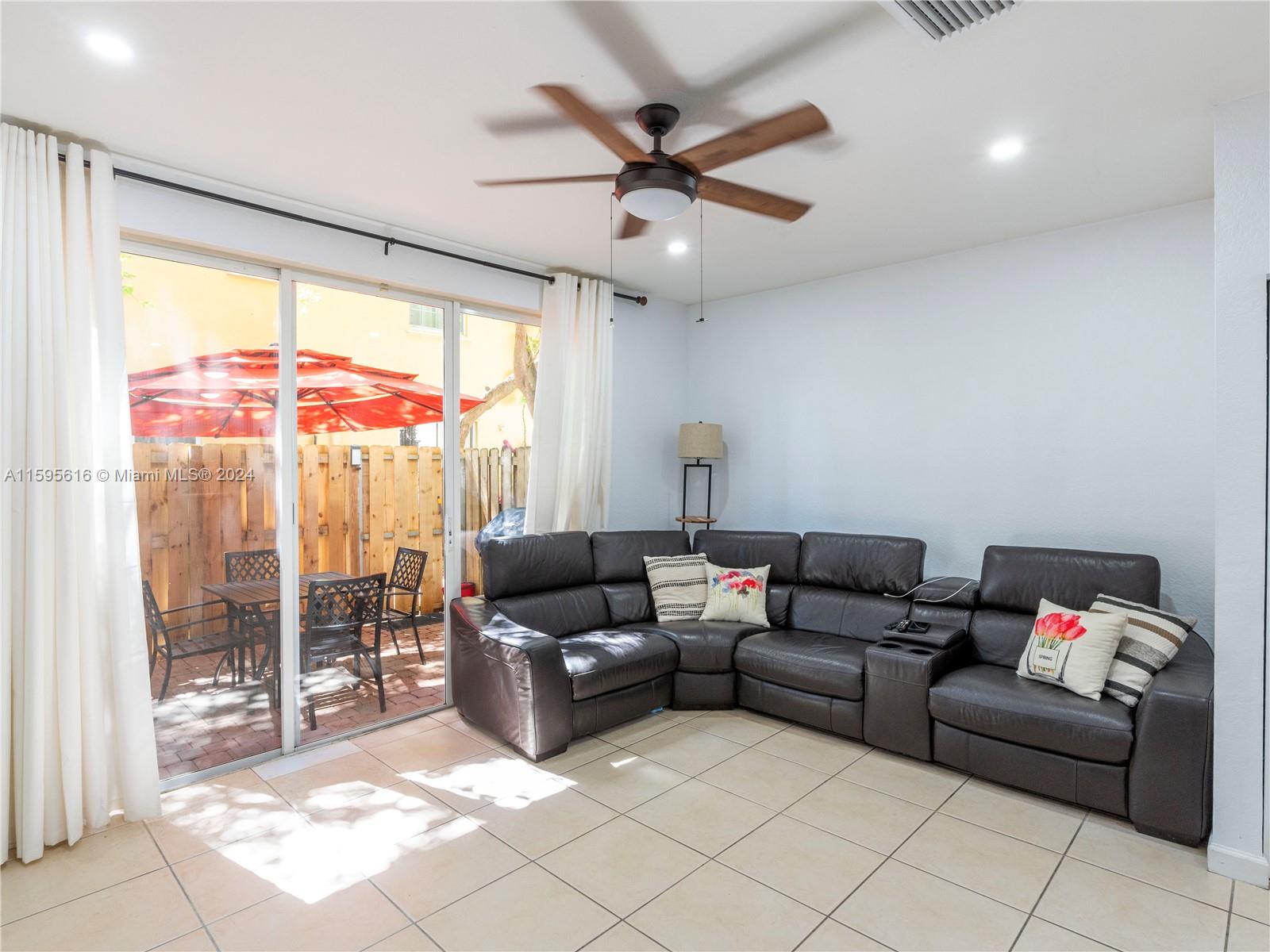 9237 Southwest 227th Street, Unit 6 Cutler Bay, FL 33190 - Photo 15 of 41 a living room with furniture and a floor to ceiling window