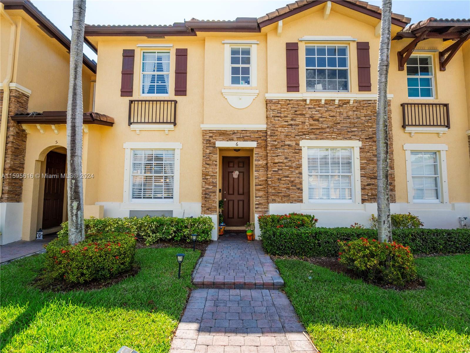 9237 Southwest 227th Street, Unit 6 Cutler Bay, FL 33190 - Photo 2 of 41 a front view of a house having yard