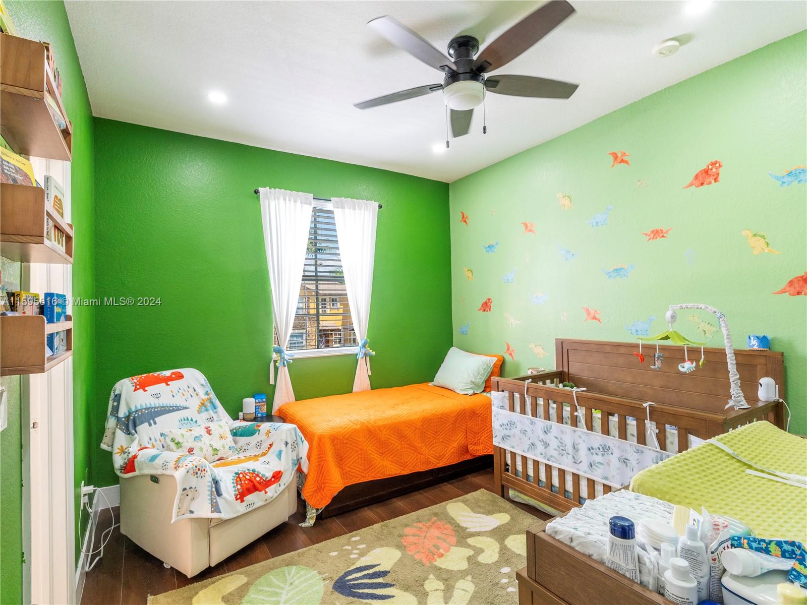 9237 Southwest 227th Street, Unit 6 Cutler Bay, FL 33190 - Photo 23 of 41 a bedroom with furniture and a window