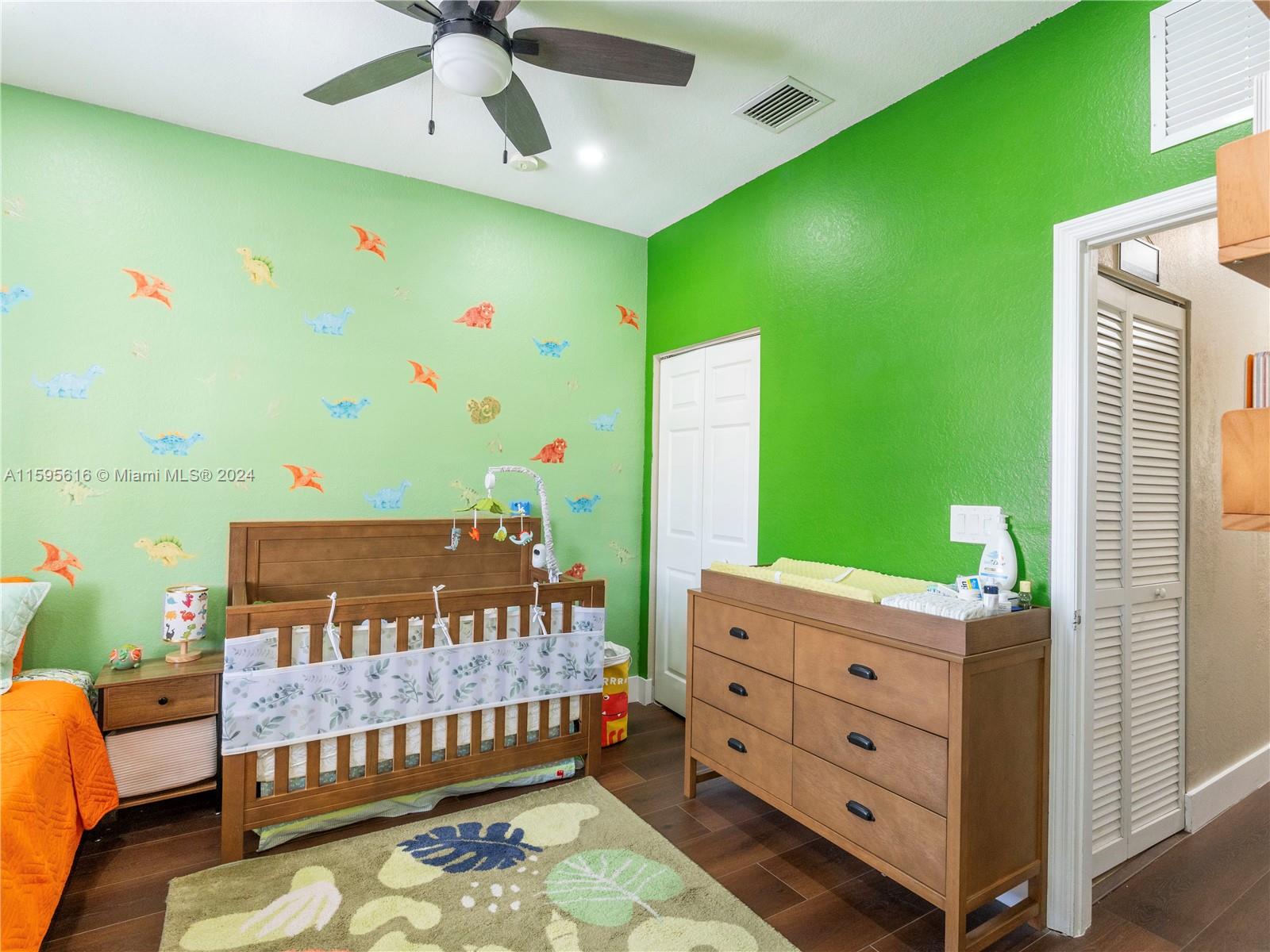 9237 Southwest 227th Street, Unit 6 Cutler Bay, FL 33190 - Photo 24 of 41 a bedroom with a bed and a dresser
