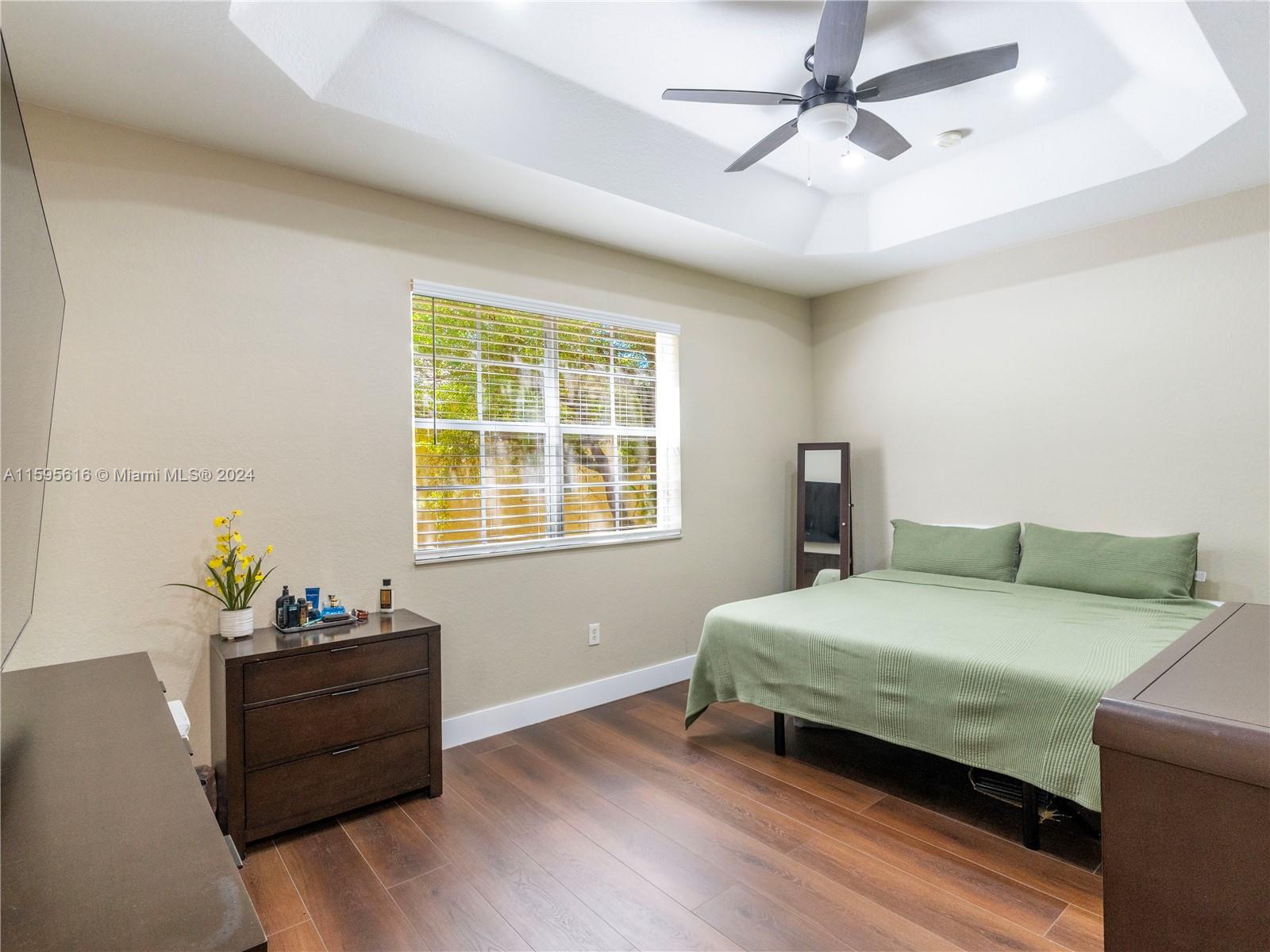 9237 Southwest 227th Street, Unit 6 Cutler Bay, FL 33190 - Photo 26 of 41 a bedroom with a bed and a window