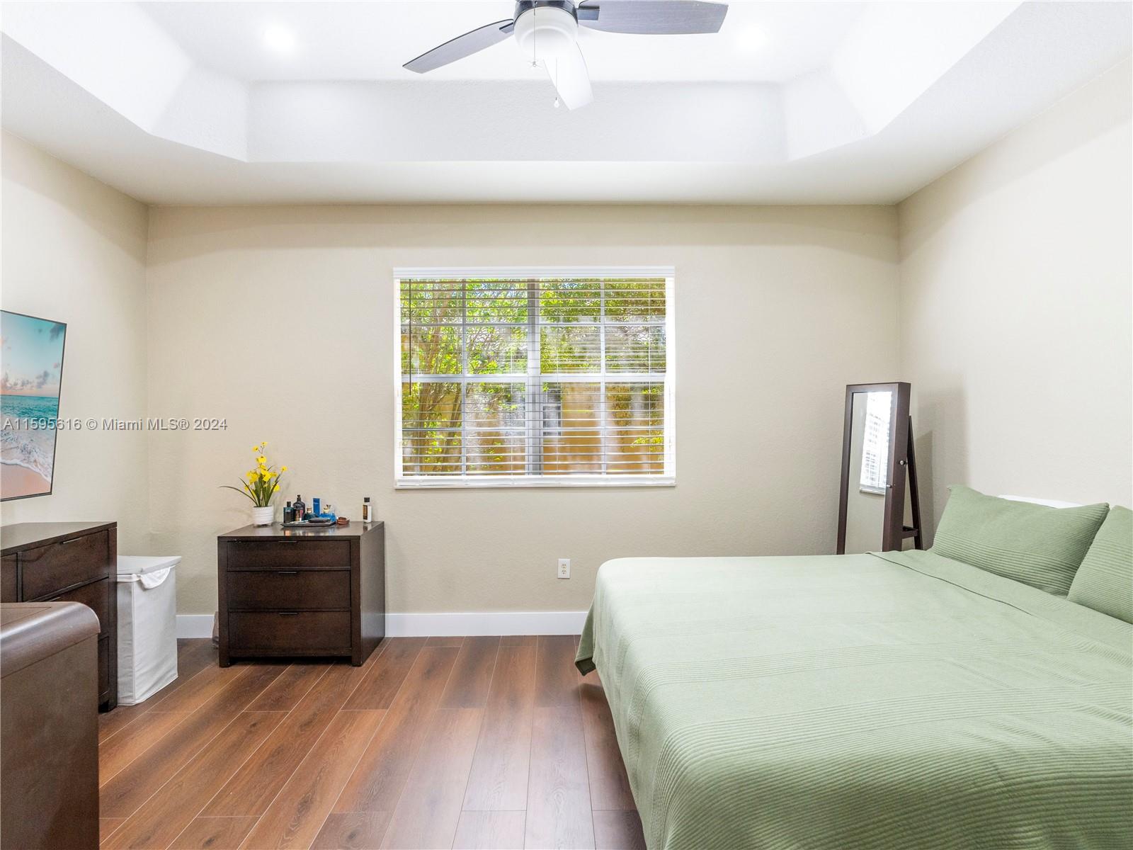 9237 Southwest 227th Street, Unit 6 Cutler Bay, FL 33190 - Photo 27 of 41 a bedroom with a bed and a window