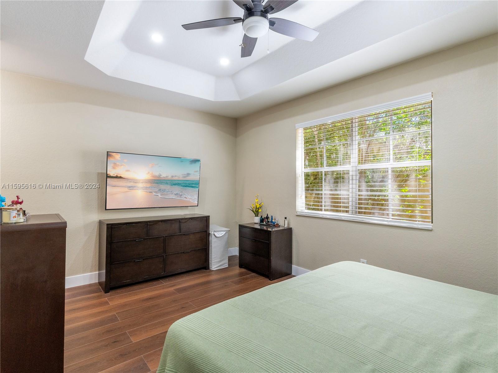 9237 Southwest 227th Street, Unit 6 Cutler Bay, FL 33190 - Photo 28 of 41 a bedroom with a bed and a dresser