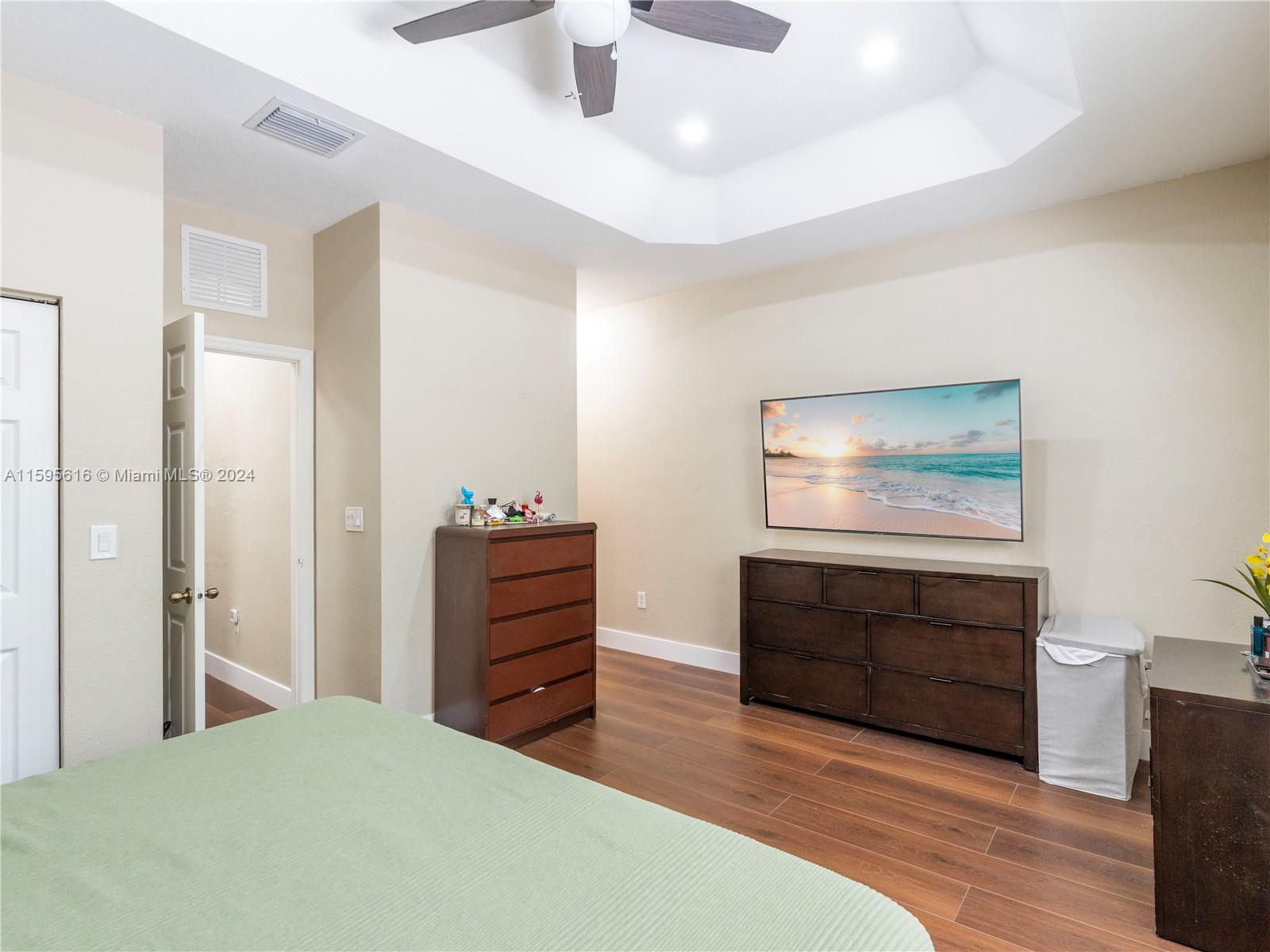 9237 Southwest 227th Street, Unit 6 Cutler Bay, FL 33190 - Photo 29 of 41 a bedroom with a bed and a dresser