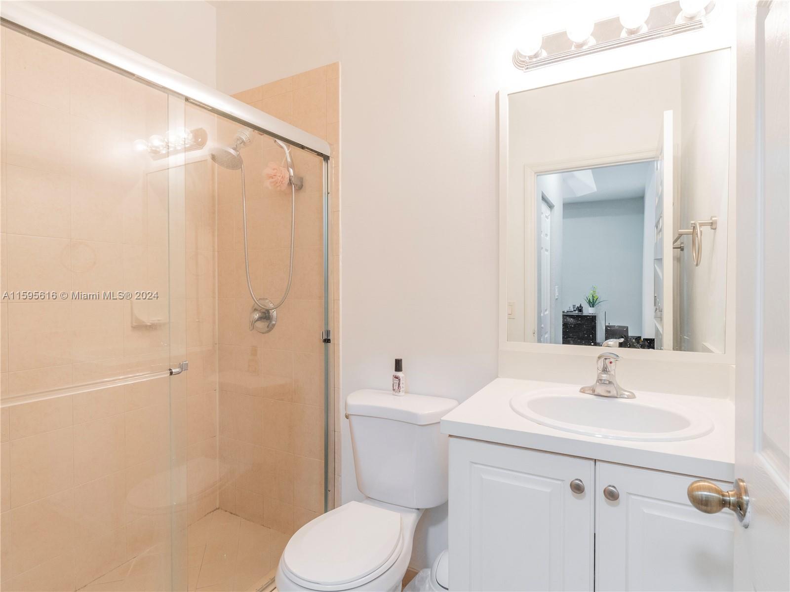 9237 Southwest 227th Street, Unit 6 Cutler Bay, FL 33190 - Photo 31 of 41 a bathroom with a sink a toilet and shower