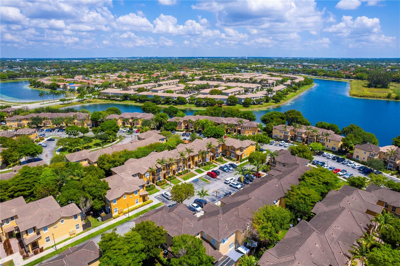 9237 Southwest 227th Street, Unit 6 Cutler Bay, FL 33190 - Photo 32 of 41 an aerial view of residential houses with outdoor space and ocean view