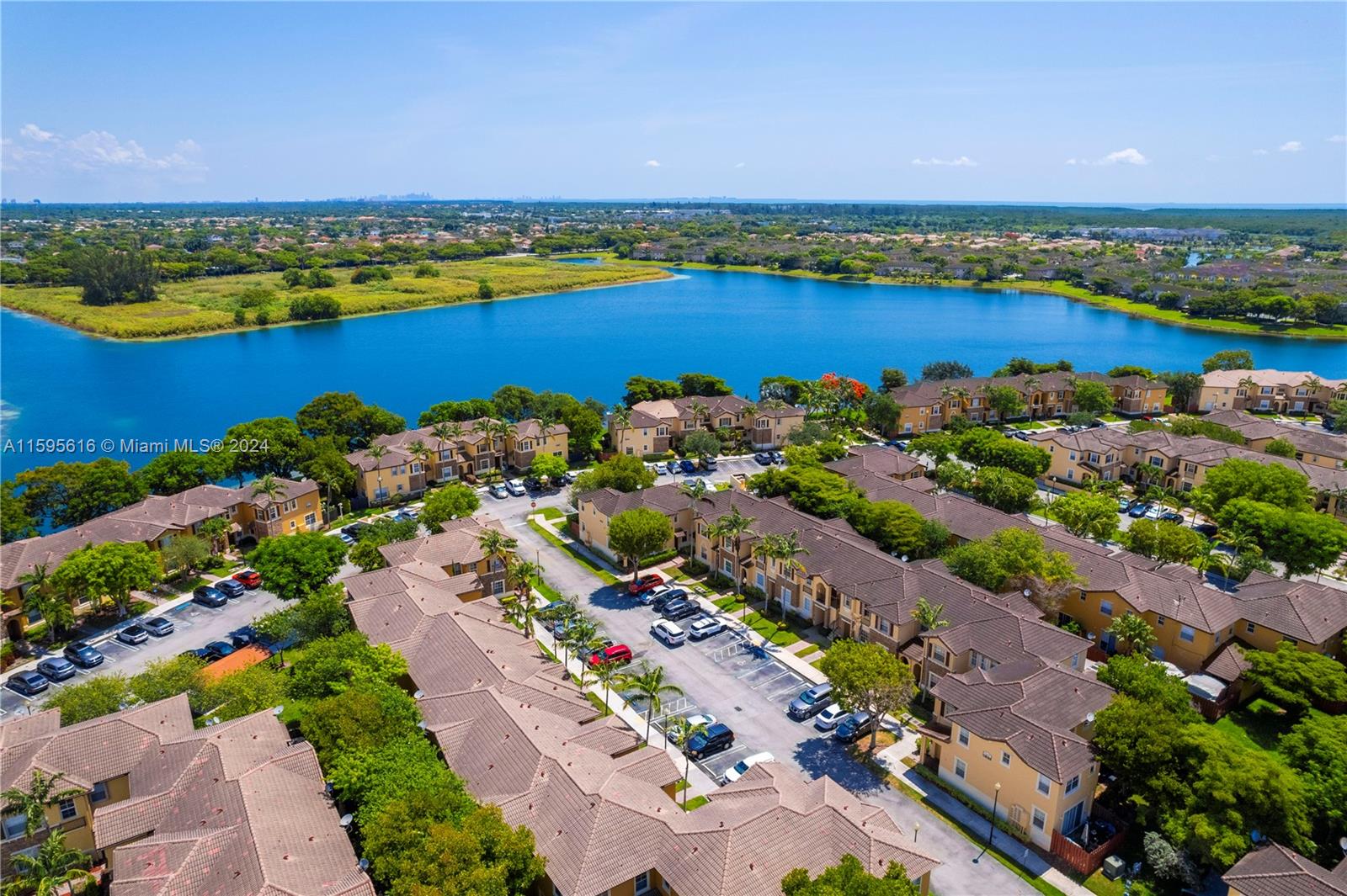 9237 Southwest 227th Street, Unit 6 Cutler Bay, FL 33190 - Photo 34 of 41 an aerial view of ocean and residential houses with outdoor space