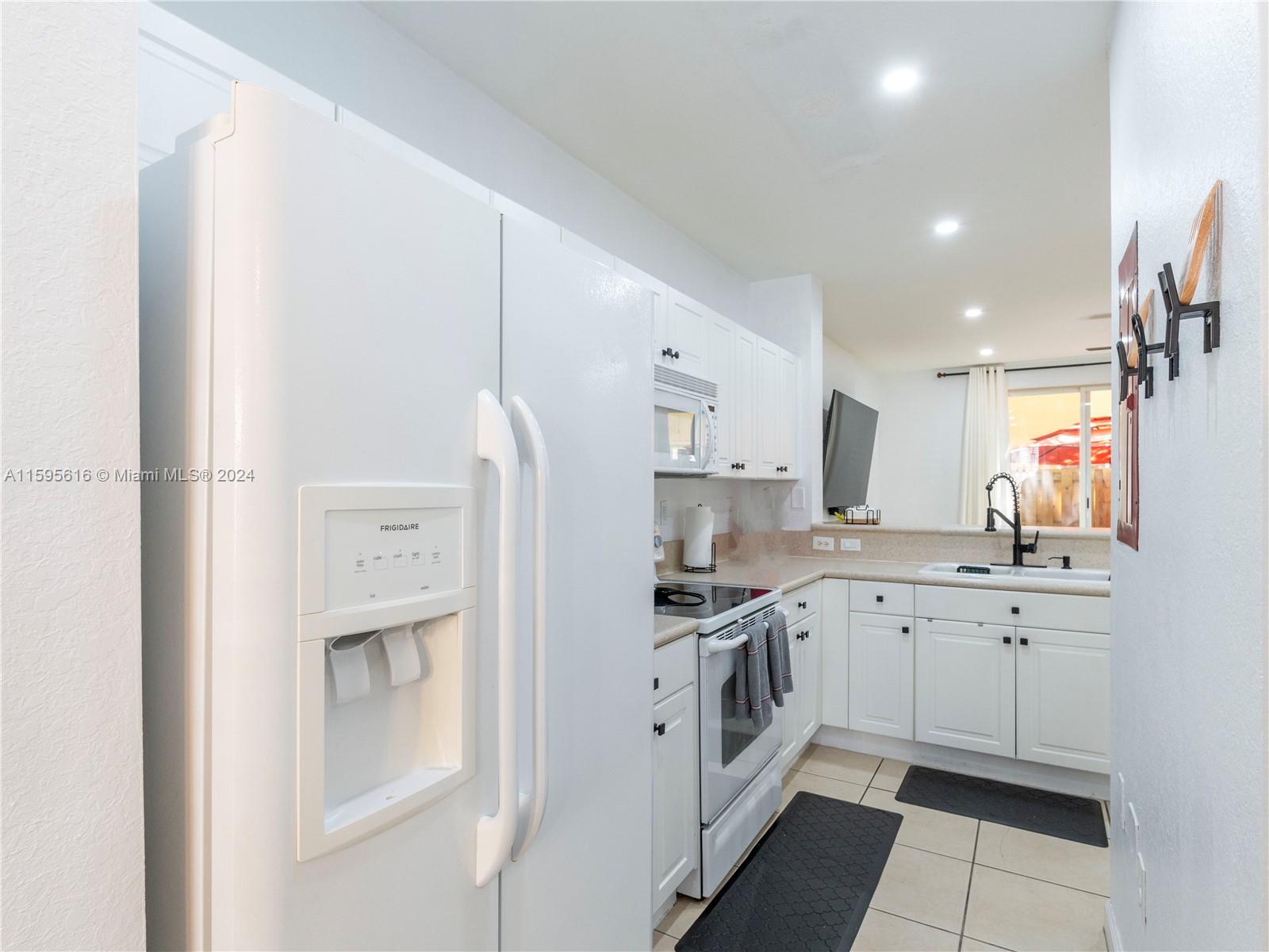 9237 Southwest 227th Street, Unit 6 Cutler Bay, FL 33190 - Photo 7 of 41 a kitchen with white cabinets and sink