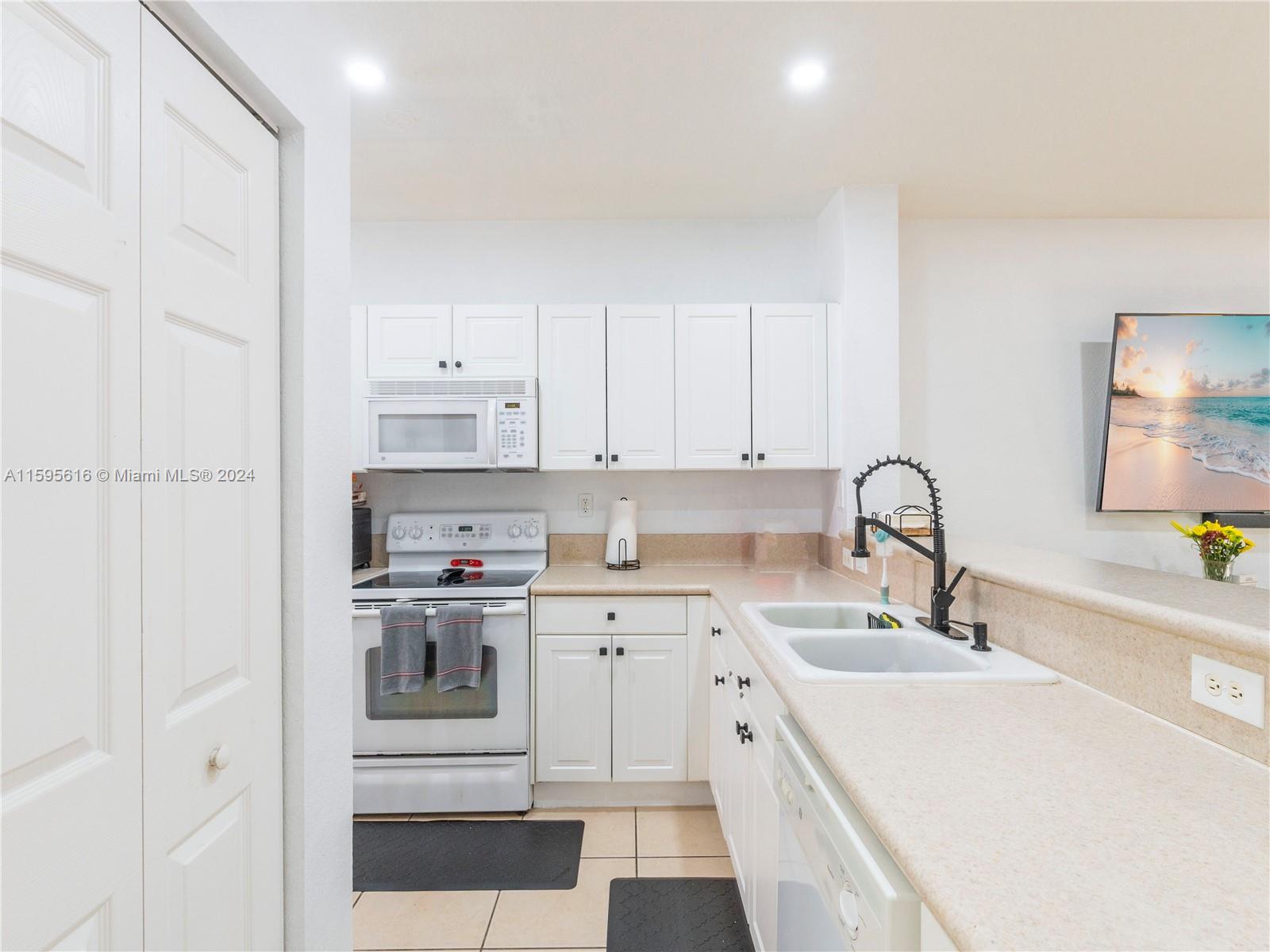 9237 Southwest 227th Street, Unit 6 Cutler Bay, FL 33190 - Photo 8 of 41 a kitchen with a sink cabinets and appliances