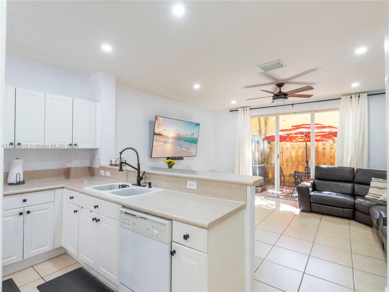 9237 Southwest 227th Street, Unit 6 Cutler Bay, FL 33190 - Photo 9 of 41 a kitchen with a sink and white cabinets