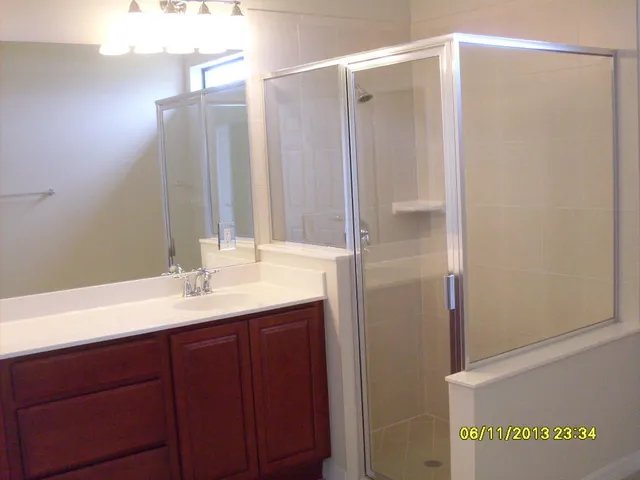 a bathroom with a double vanity sink and mirror