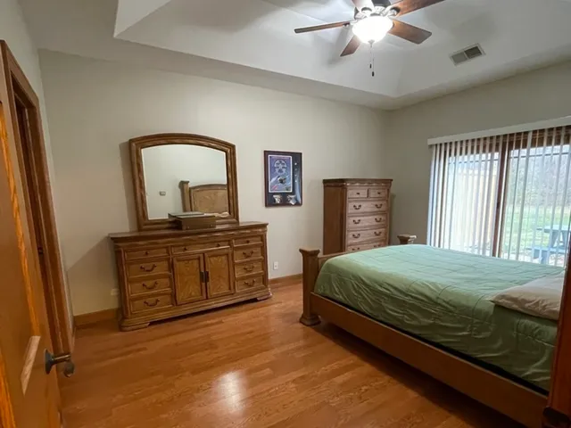 a bedroom with a bed and a dresser