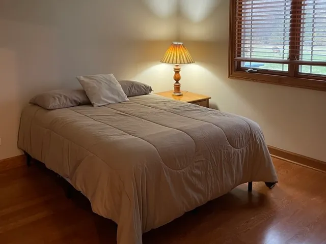 a bedroom with a bed and a window