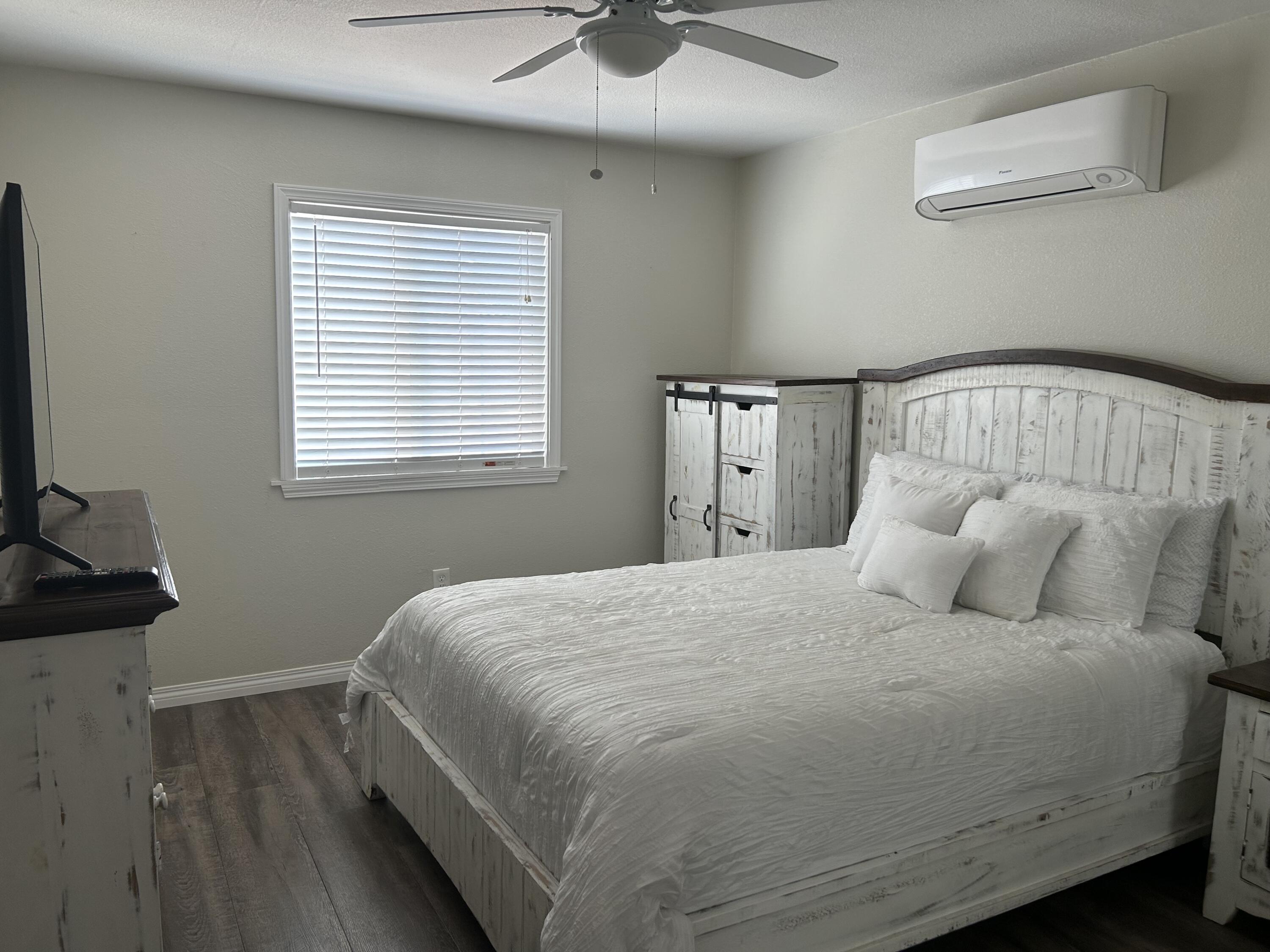 3344 West Ave L Lancaster, CA 93536 - Photo 8 of 9 a bedroom with a bed and a window