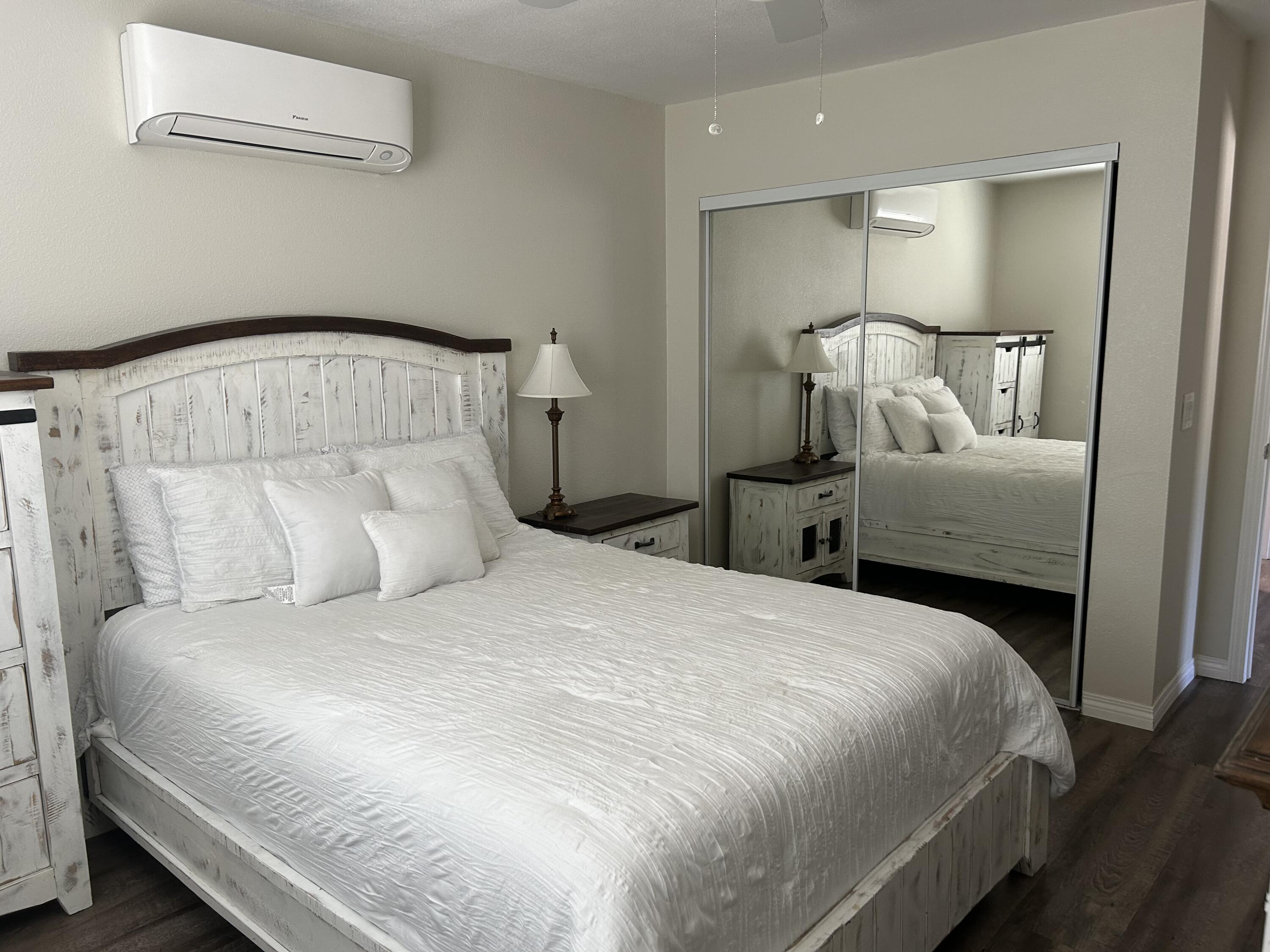 3344 West Ave L Lancaster, CA 93536 - Photo 9 of 9 a bedroom with a bed and a mirror