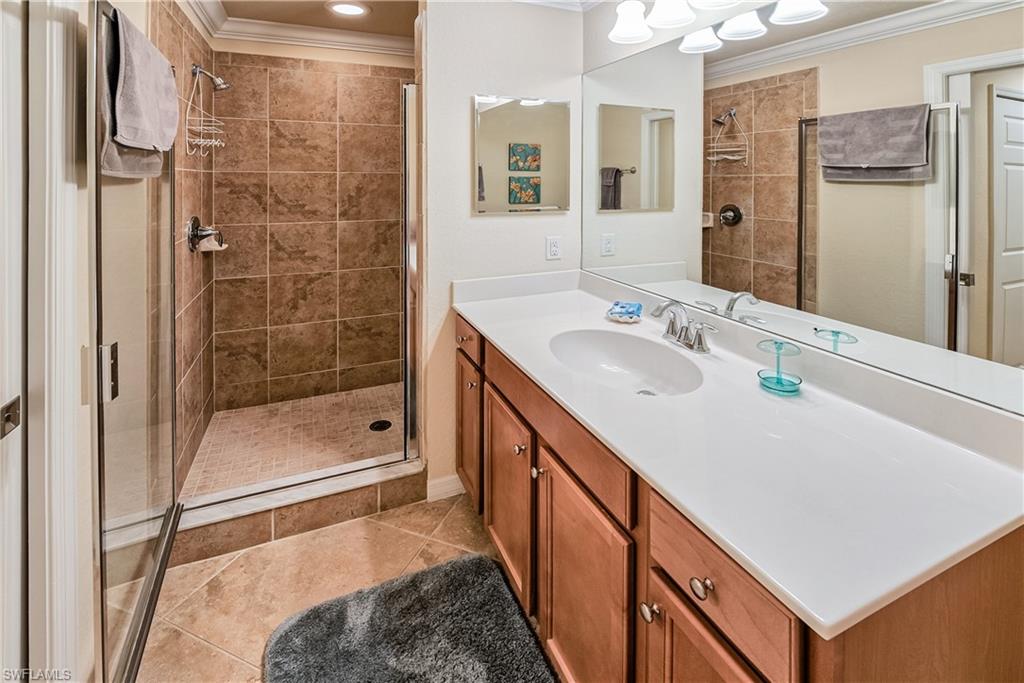 9735 Acqua Court, Unit 622 Naples, FL 34113 - Photo 12 of 34 a bathroom with a granite countertop sink mirror and shower