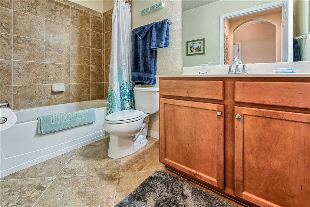 9735 Acqua Court, Unit 622 Naples, FL 34113 - Photo 15 of 34 a bathroom with a sink a toilet and a mirror