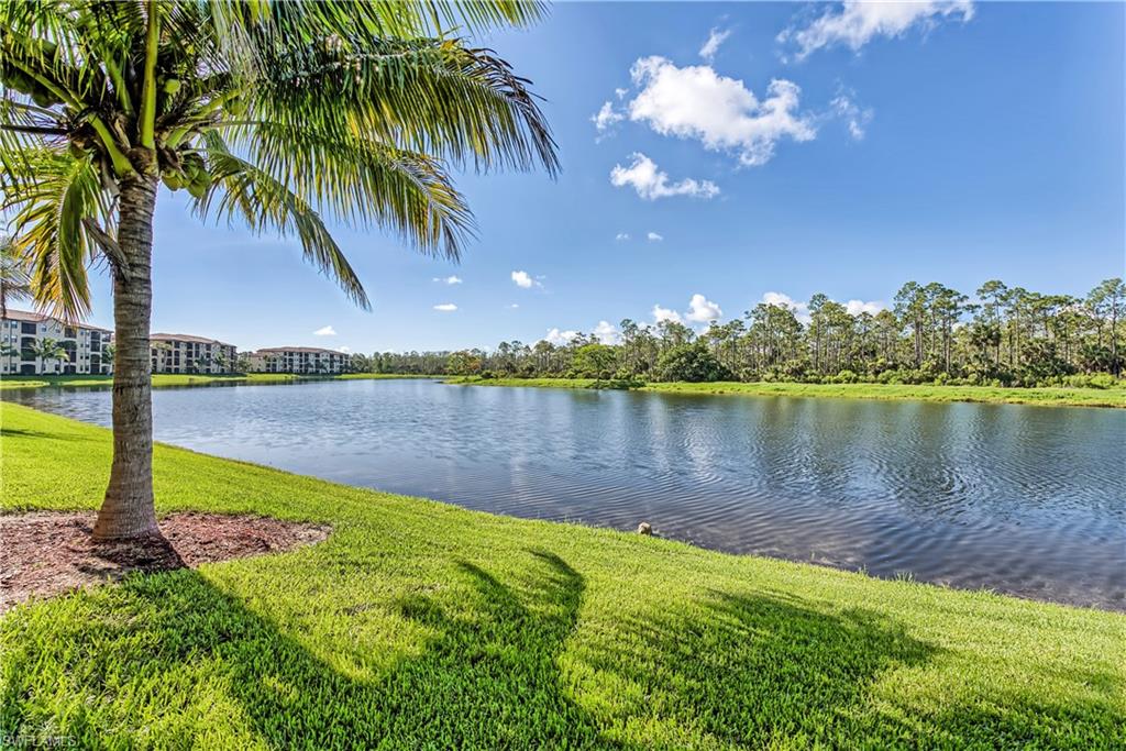 9735 Acqua Court, Unit 622 Naples, FL 34113 - Photo 18 of 34 a view of a lake with a yard