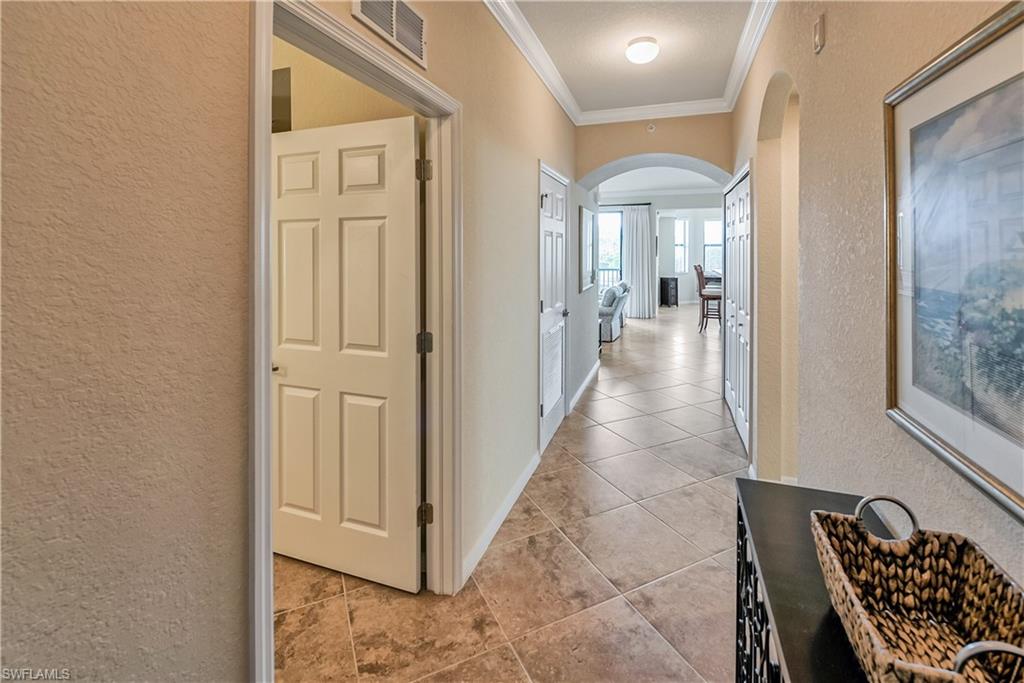 9735 Acqua Court, Unit 622 Naples, FL 34113 - Photo 3 of 34 a view of a hallway with windows and stairs