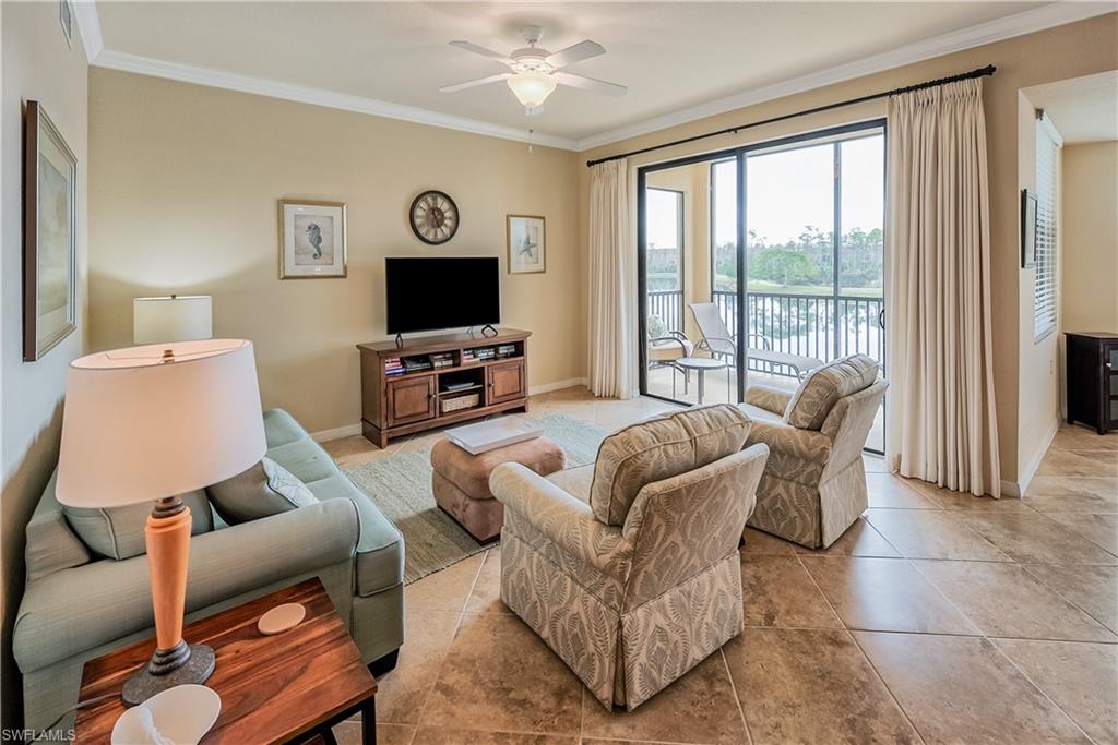 9735 Acqua Court, Unit 622 Naples, FL 34113 - Photo 4 of 34 a living room with furniture and a flat screen tv