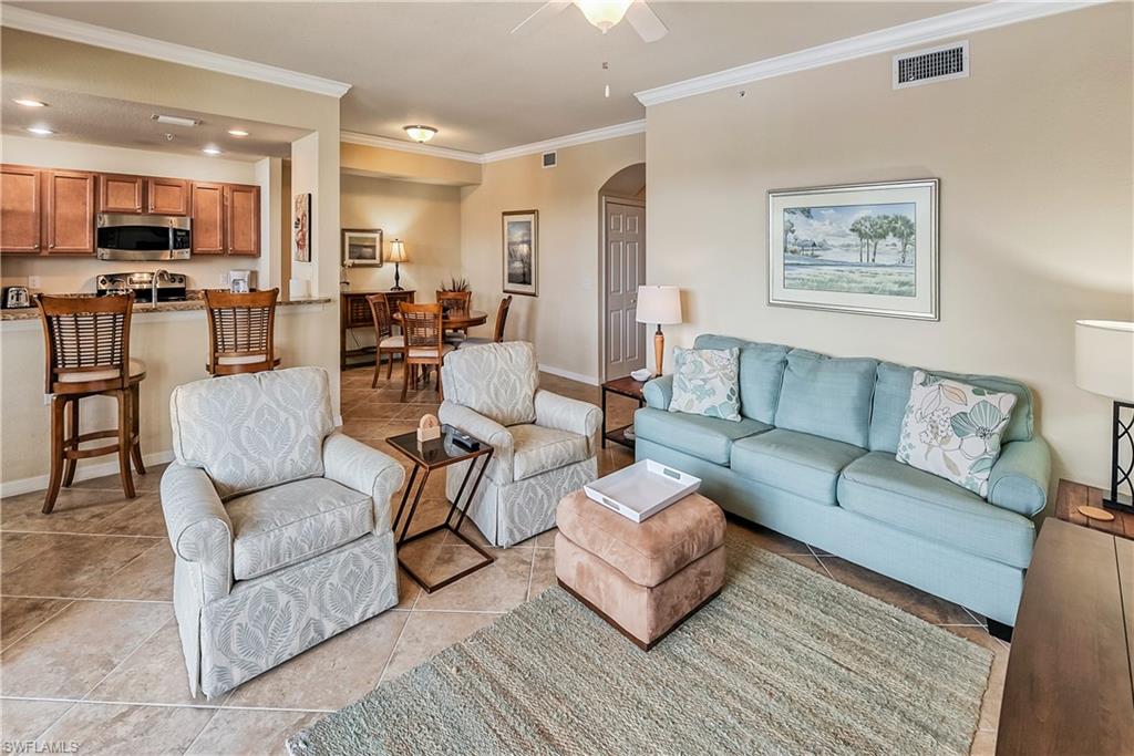 9735 Acqua Court, Unit 622 Naples, FL 34113 - Photo 5 of 34 a living room with furniture kitchen and a wooden floor