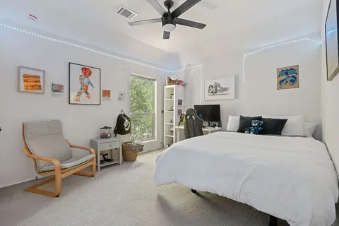 a bed room with a bed and a chair