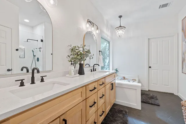 a bathroom with a sink vanity and a mirror