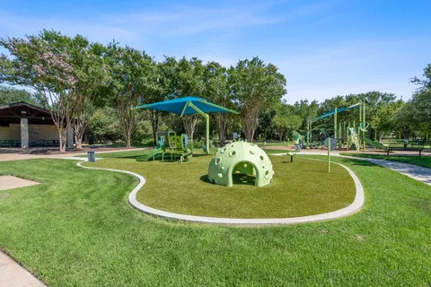 a view of a park with large trees