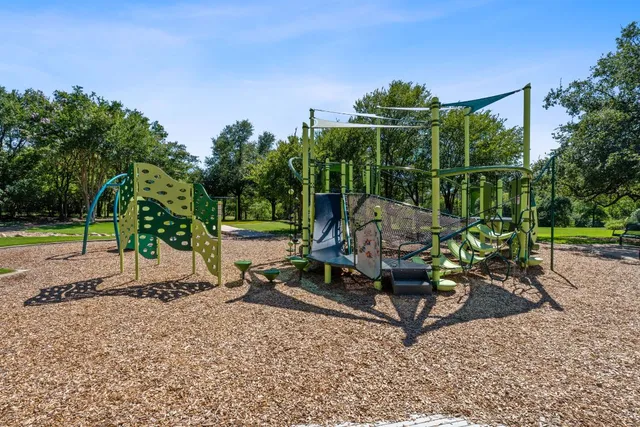 a view of a small house with a big yard