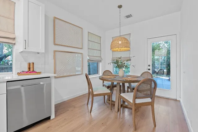 a view of a dining room with furniture window and wooden floor