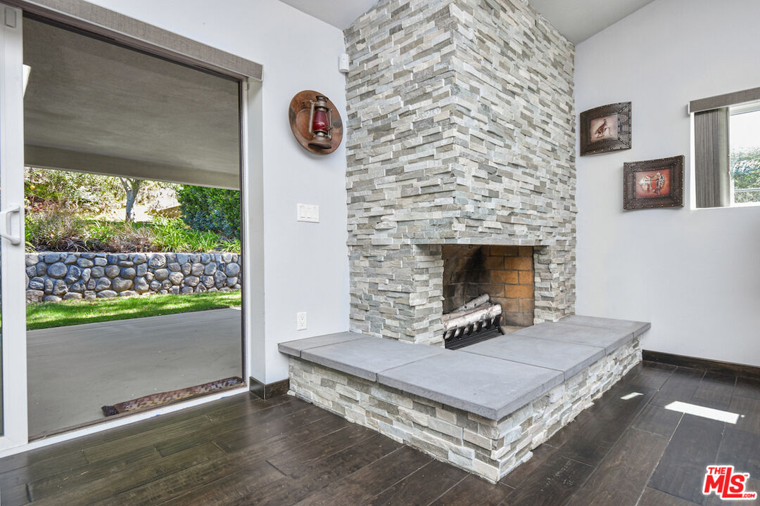 2447 Stonyvale Road Tujunga, CA 91042 - Photo 7 of 33 a living room with a table and a fireplace