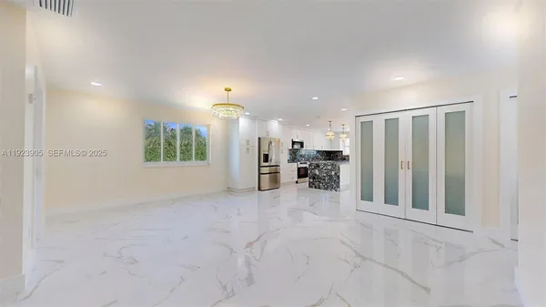 a kitchen with stainless steel appliances a sink a stove and a refrigerator