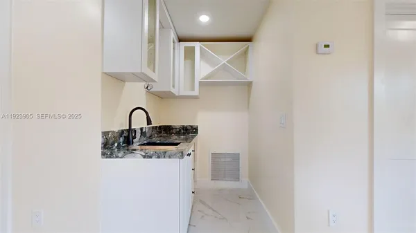 a kitchen with a stove a sink a refrigerator and a counter top space