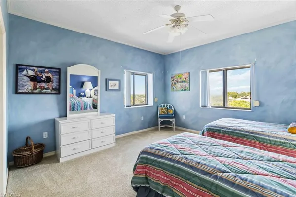 a bedroom with two beds and a chandelier