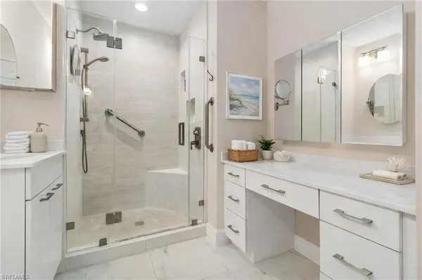 a bathroom with a shower sink and mirror