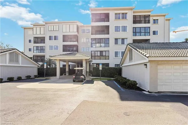 a front view of a building with a yard outdoor seating and barbeque oven