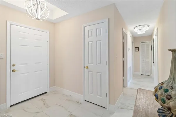 a kitchen with stainless steel appliances granite countertop a stove refrigerator a dining table and chairs with wooden floor